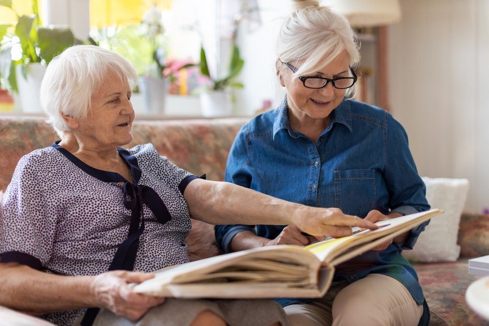 Senior woman sharing memories with caregiver