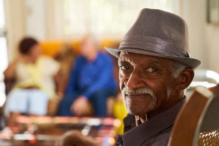Elderly man wearing a hat smiling