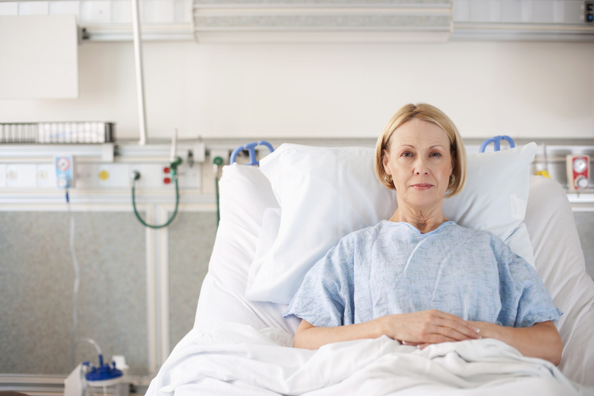 An older woman in a hospital bed receiving post hospital care