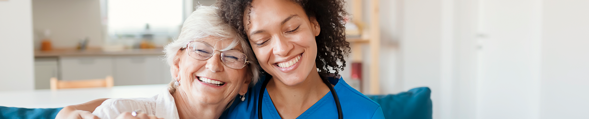 nurse aid embracing senior resident smiling