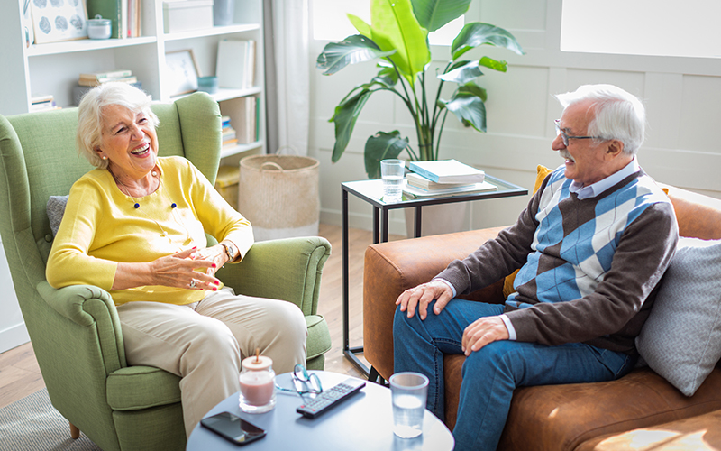 senior couple laughing in living room